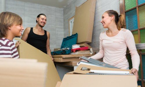 Furniture collection team handling bulky items in a Kensington residential street