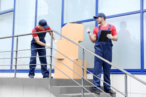 Removal van and moving crew in Kensington street with residential buildings