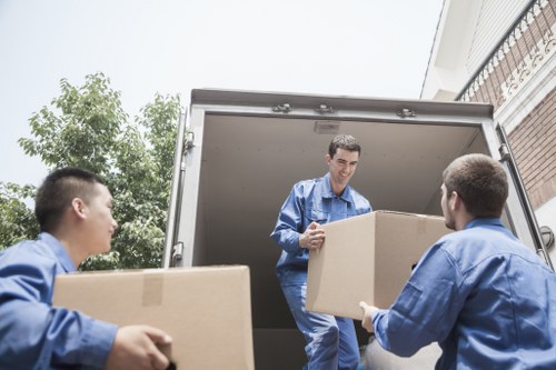Local crew removing sofas and office furniture from a Kensington property