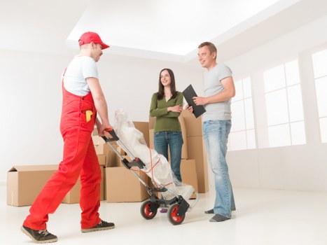 Packed moving boxes and furniture ready for removals in Kensington home